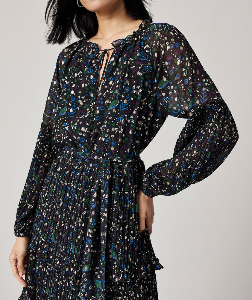 Model is wearing UNTUCKit Paloma dress in black print.