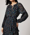 Model is wearing UNTUCKit Paloma dress in black print.