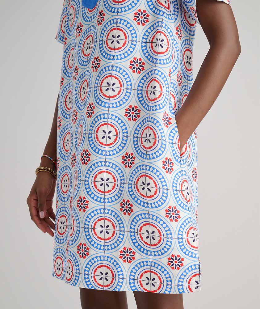 Model are wearing UNTUCKit Paola dress in printed tile blue. 