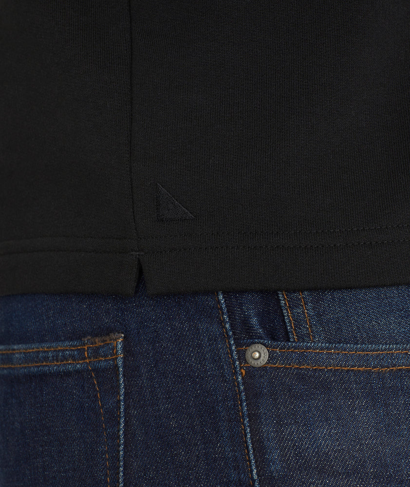 Model is wearing UNTUCKit Snap Fleece Pullover in black.