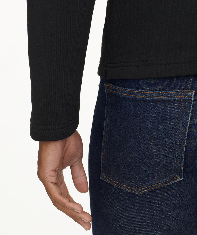 Model is wearing UNTUCKit Snap Fleece Pullover in black.