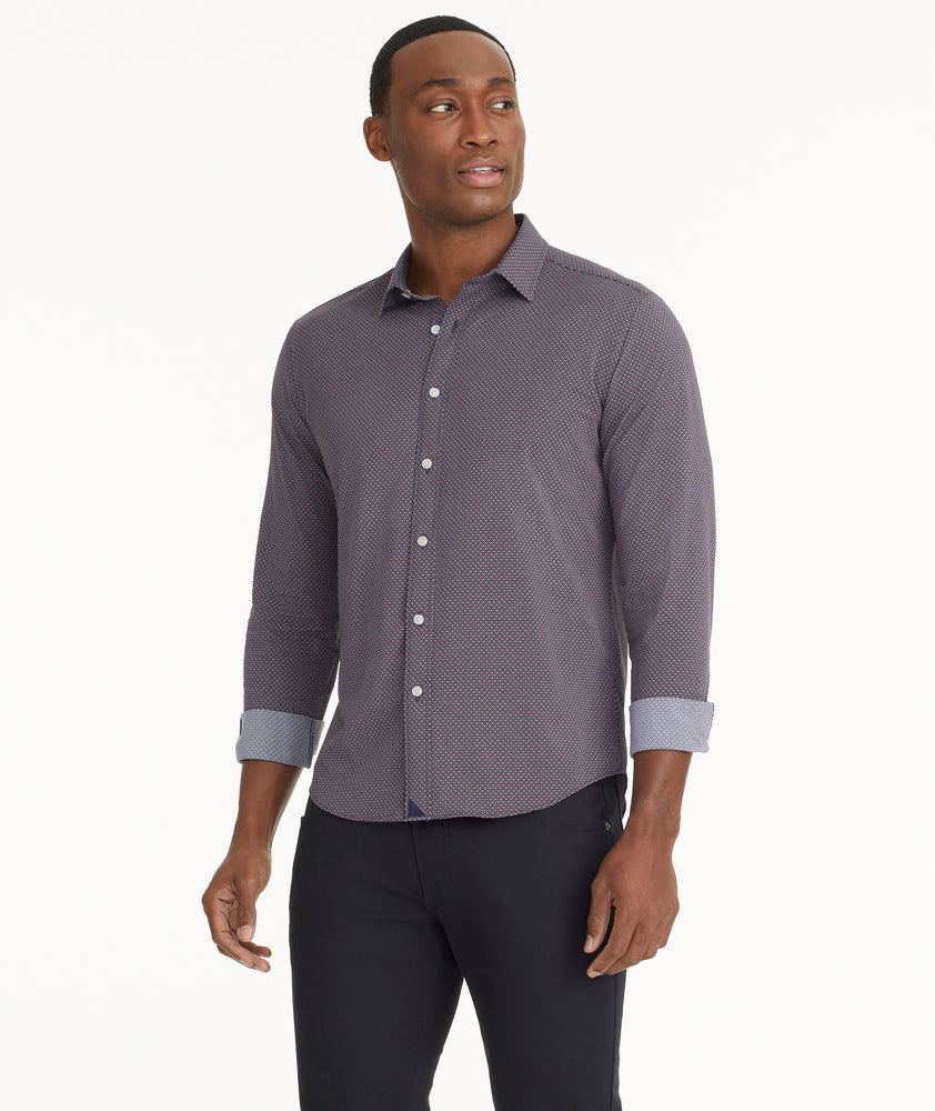 Model is wearing UNTUCKit Wrinkle-Free Performance Peraldi Shirt in Navy & Red Micro Print.
