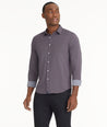 Model is wearing UNTUCKit Wrinkle-Free Performance Peraldi Shirt in Navy & Red Micro Print.
