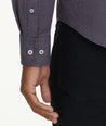 Model is wearing UNTUCKit Wrinkle-Free Performance Peraldi Shirt in Navy & Red Micro Print.