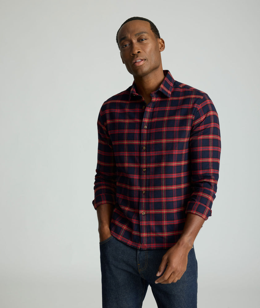 Model is wearing UNTUCKit Perking in navy and red windowpane. 