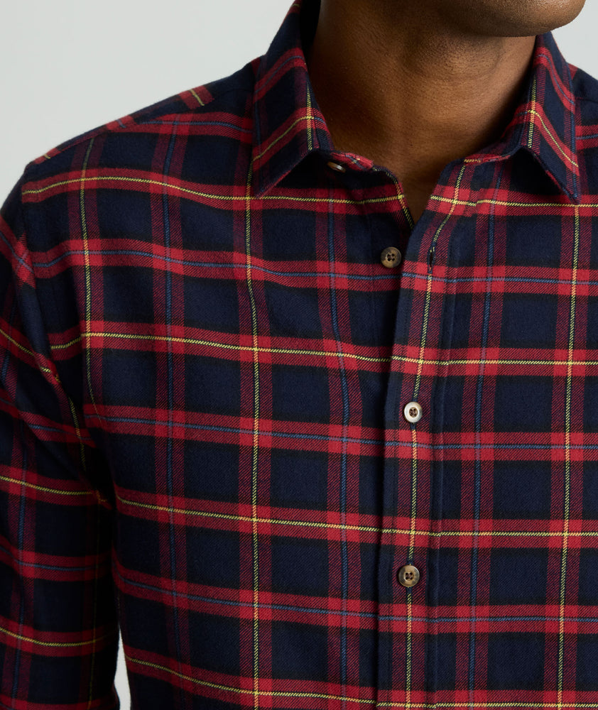 Model is wearing UNTUCKit Perking in navy and red windowpane. 