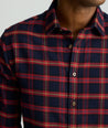 Model is wearing UNTUCKit Perking in navy and red windowpane. 