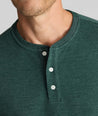 Model is wearing UNTUCKit Petrelson henley in forest green. 
