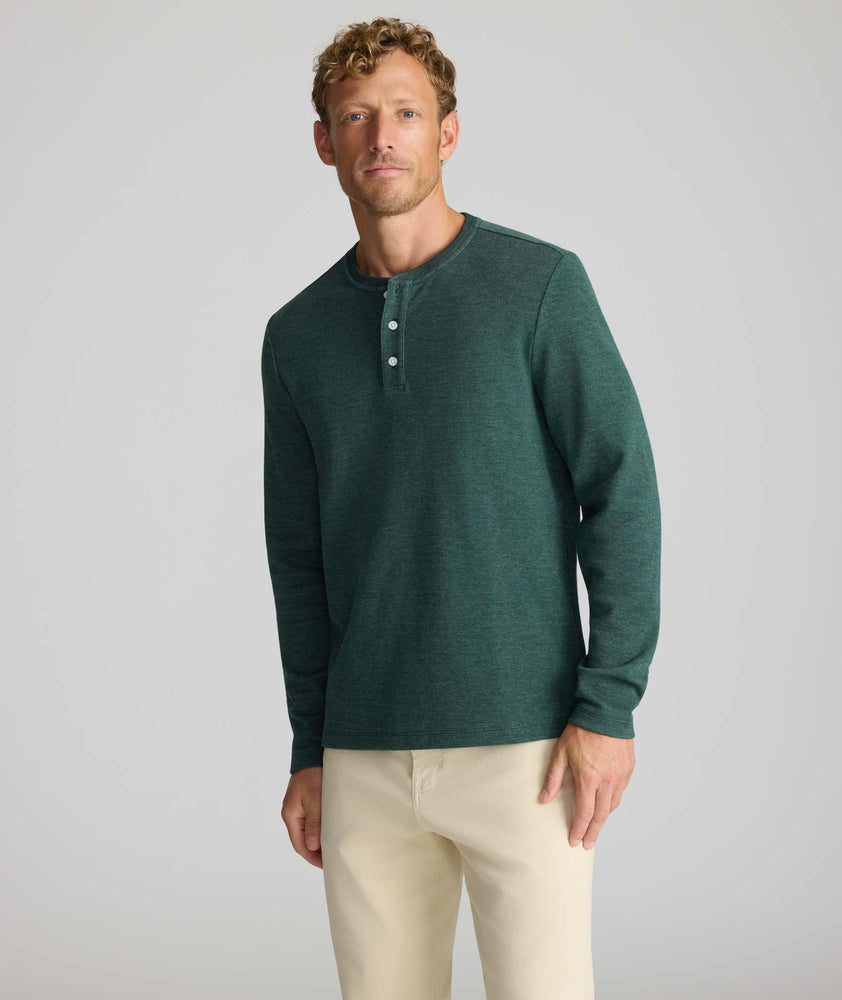 Model is wearing UNTUCKit Petrelson henley in forest green. 