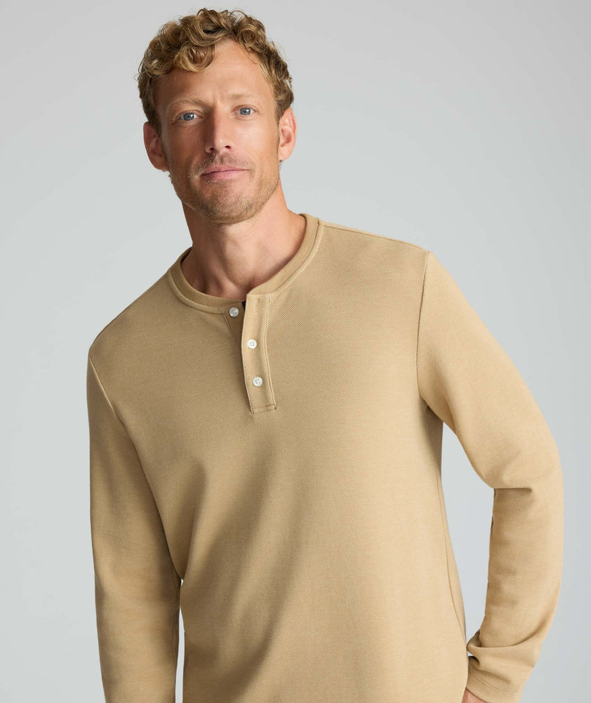 Model is wearing UNTUCKit Petrelson henley in Tan. 