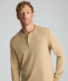 Model is wearing UNTUCKit Petrelson henley in Tan. 