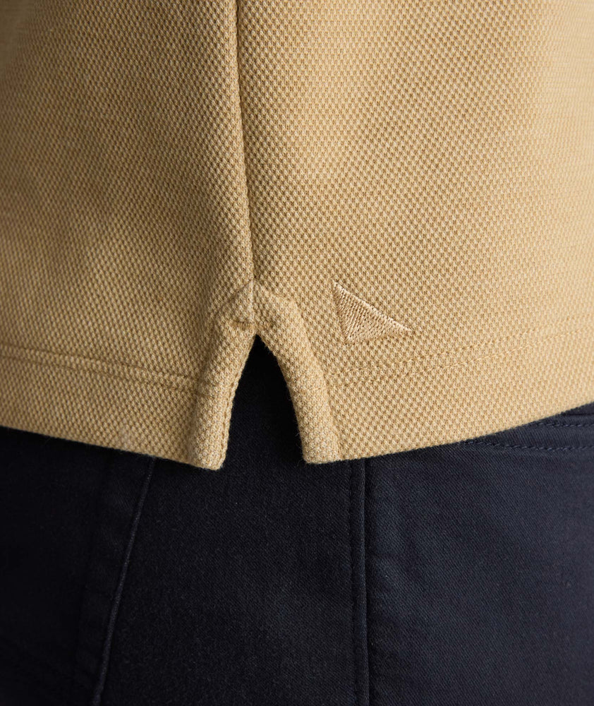 Model is wearing UNTUCKit Petrelson henley in Tan. 