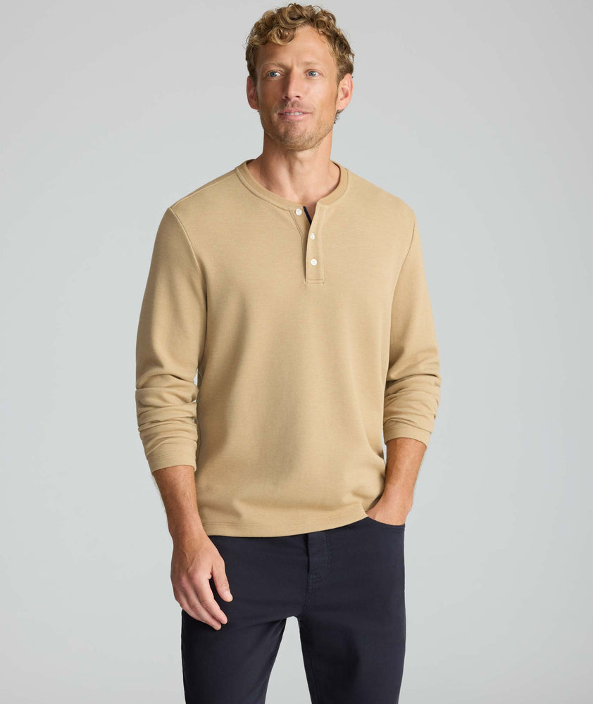 Model is wearing UNTUCKit Petrelson henley in Tan. 