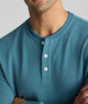 Model is wearing UNTUCKit Petrelson henley in Teal. 