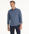 Model is wearing UNTUCKit Wrinkle-Free Performance Pierro Shirt in Navy & Blue Plaid.