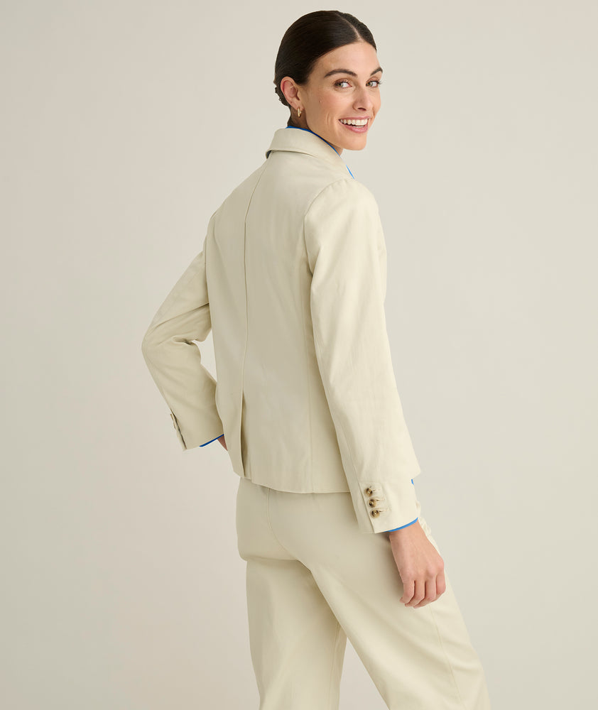 Model is wearing UNTUCKit Piper blazer in tan. 