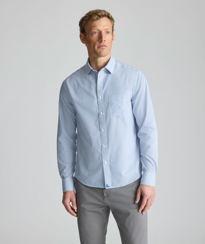 Model is wearing UNTUCKit Wrinkle-Free Pizarro Shirt in blue. 