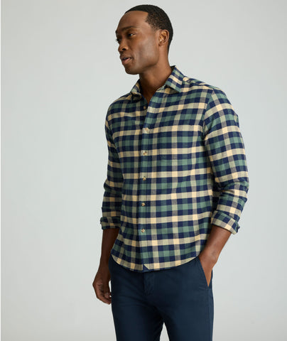 Model is wearing UNTUCKit Flannel Plenville Shirt in green check. 