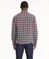 Model is wearing UNTUCKit Brushed Overshirt in Gray & Maroon Check.