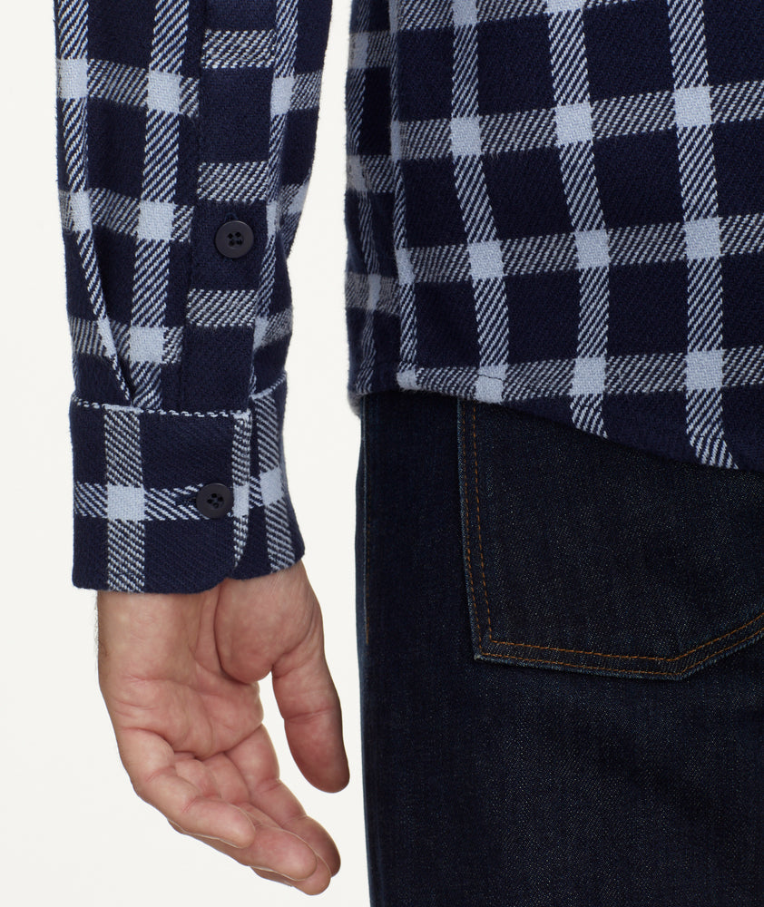 Model is wearing UNTUCKit Brushed Overshirt in Navy & Light Blue Check.