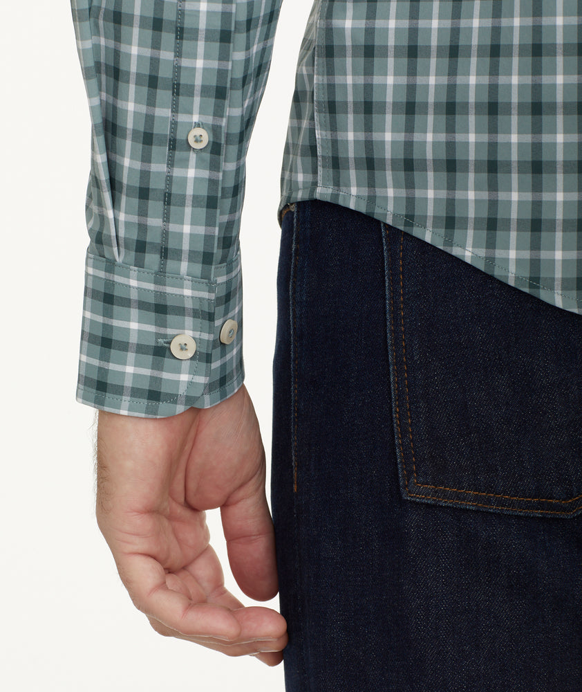 Model is wearing UNTUCKit Wrinkle-Free Performance Prescott Shirt in Sage Green Check.