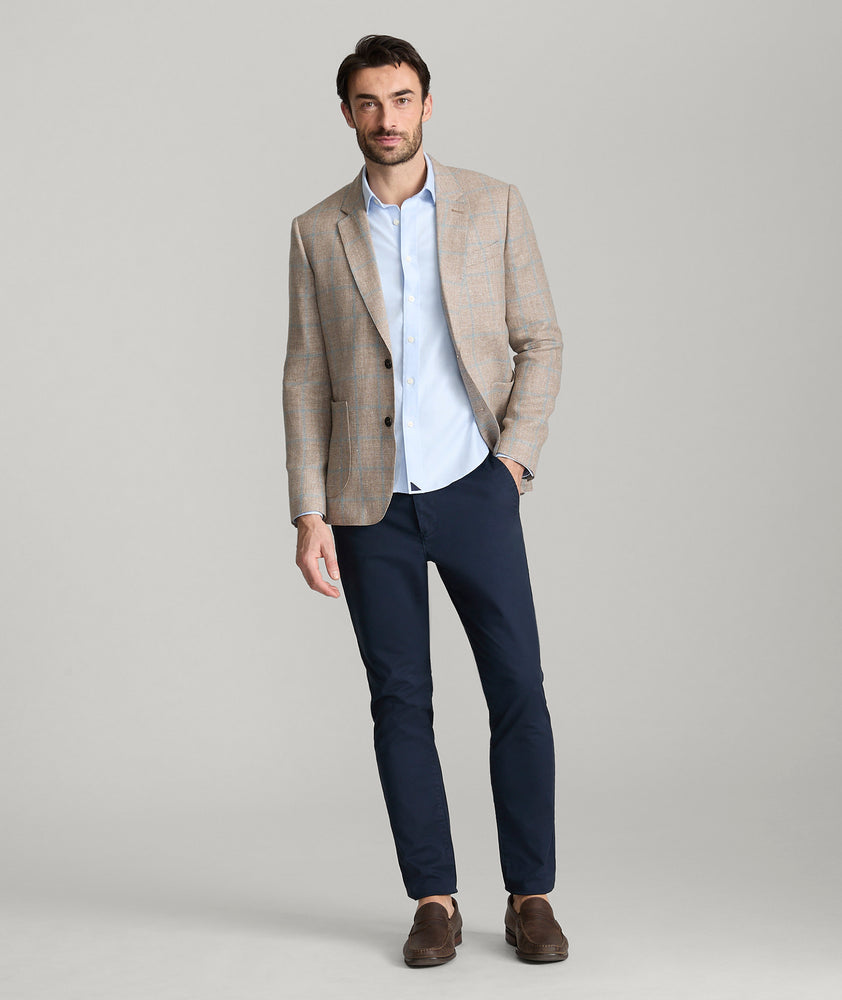 Model is wearing UNTUCKit price sport coat in tan. 