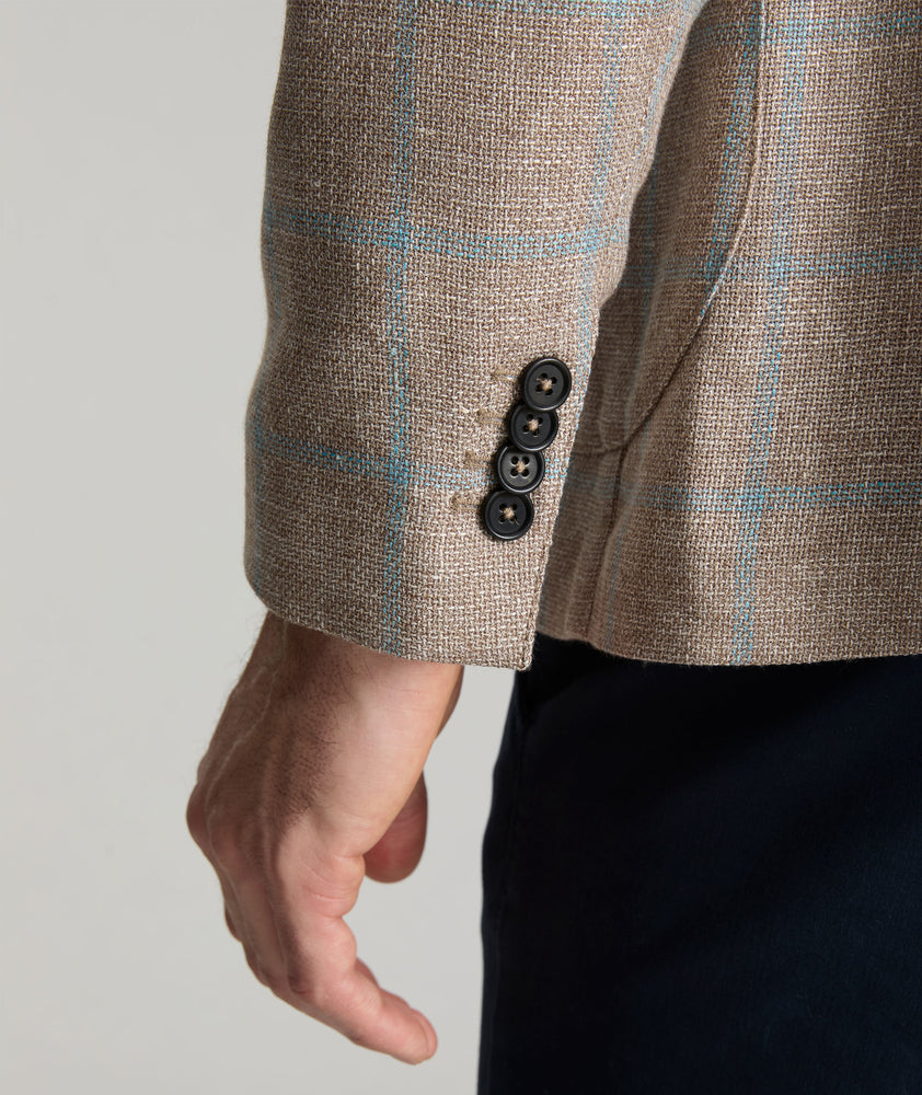 Model is wearing UNTUCKit price sport coat in tan. 