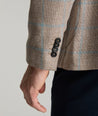 Model is wearing UNTUCKit price sport coat in tan. 