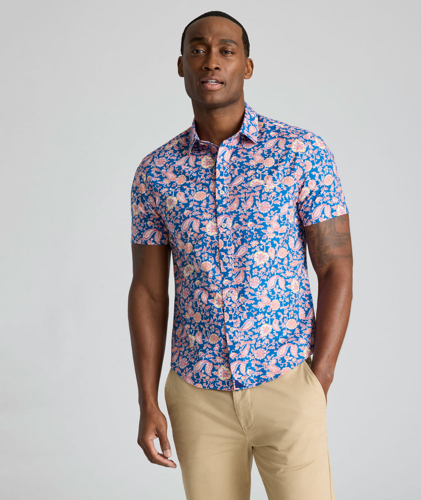 Model is wearing UNTUCKit Quarry cotton linen shirt in pink print. 