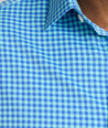 Model is wearing UNTUCKit Quinby performance gingham shirt in blue. 