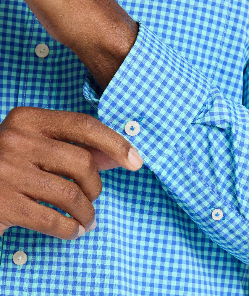 Model is wearing UNTUCKit Quinby performance gingham shirt in blue. 