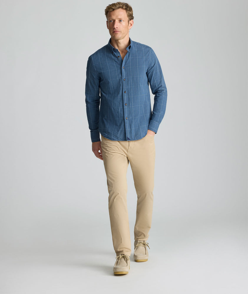 Model is wearing UNTUCKit Vintage Wash Quinnell Shirt in navy. 