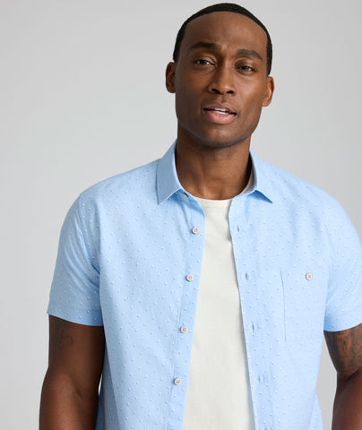 Model is wearing UNTUCKit Quinn cotton linen top in blue print. 