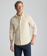 Model is wearing UNTUCKit Vintage Wash Quinnell Shirt in tan. 