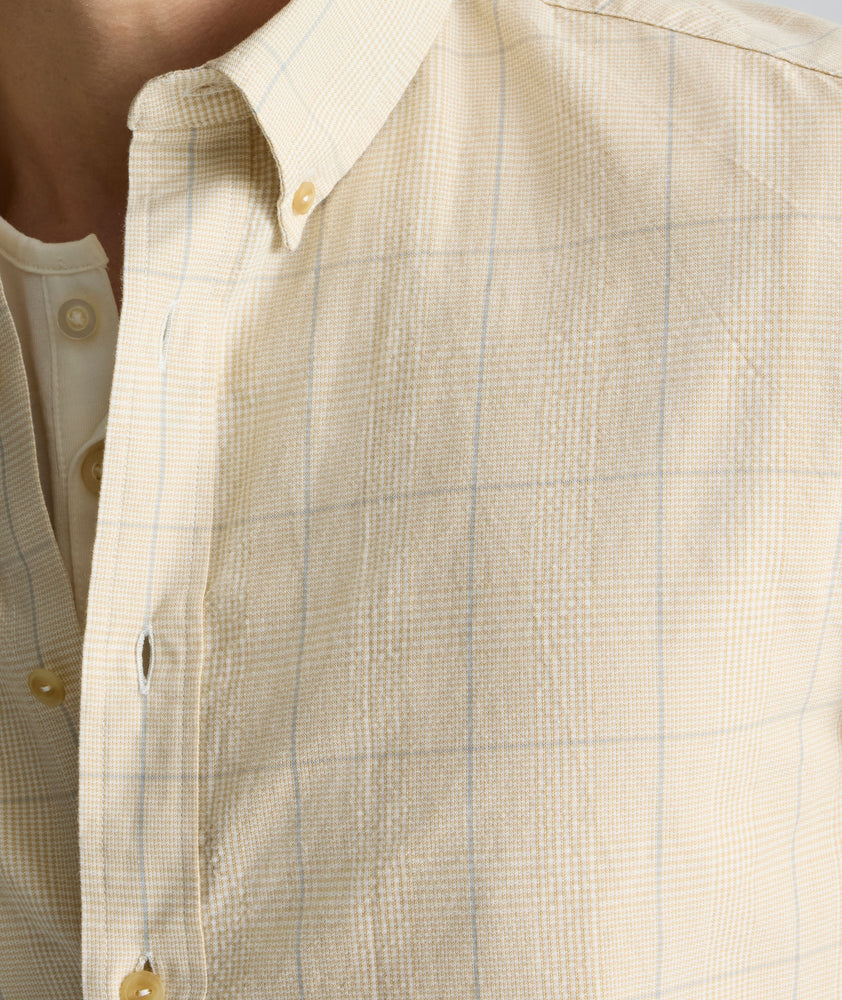 Model is wearing UNTUCKit Vintage Wash Quinnell Shirt in tan. 