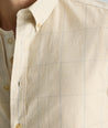 Model is wearing UNTUCKit Vintage Wash Quinnell Shirt in tan. 