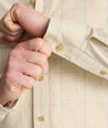 Model is wearing UNTUCKit Vintage Wash Quinnell Shirt in tan. 