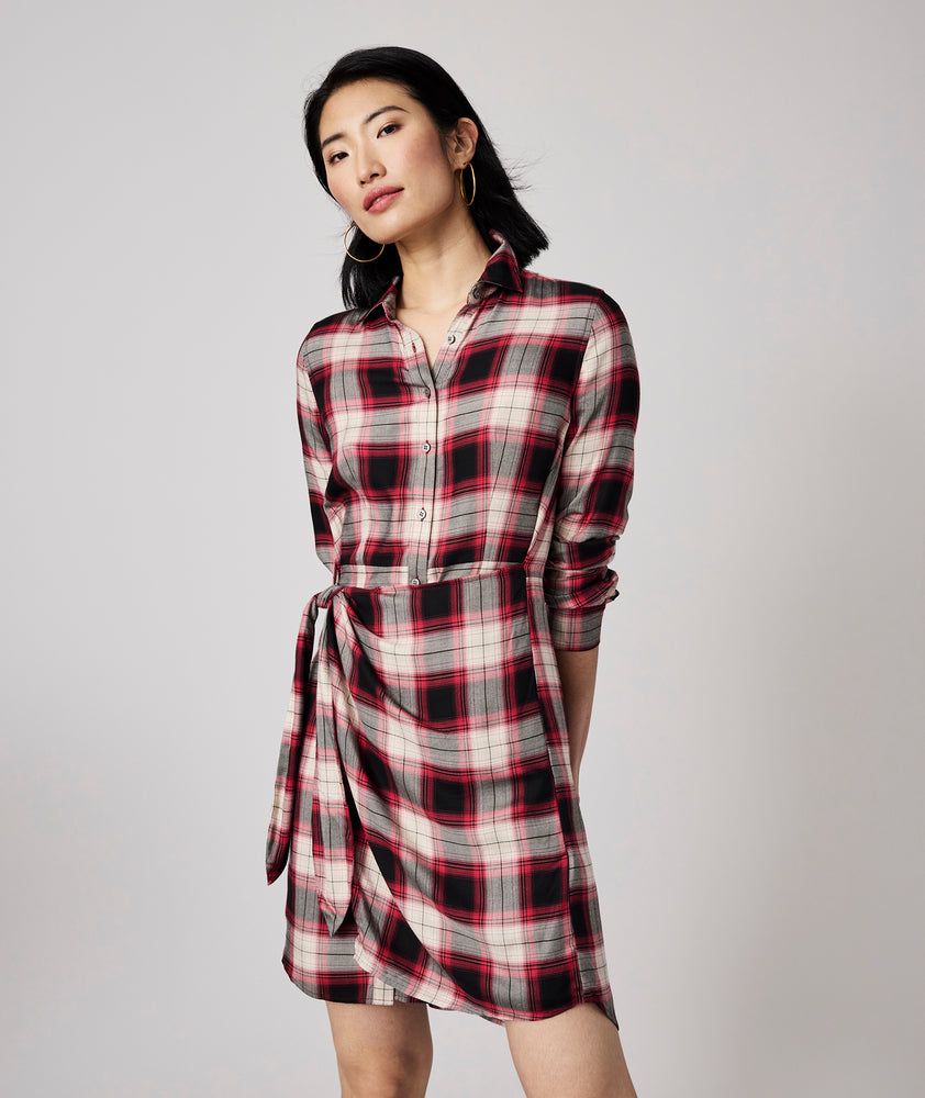 Model is wearing UNTUCKit Rachel dress in red plaid.