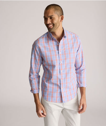 Model is wearing UNTUCKit ravenswood wrinkle free plaid plaid shirt in orange. 