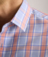 Model is wearing UNTUCKit ravenswood wrinkle free plaid plaid shirt in orange. 