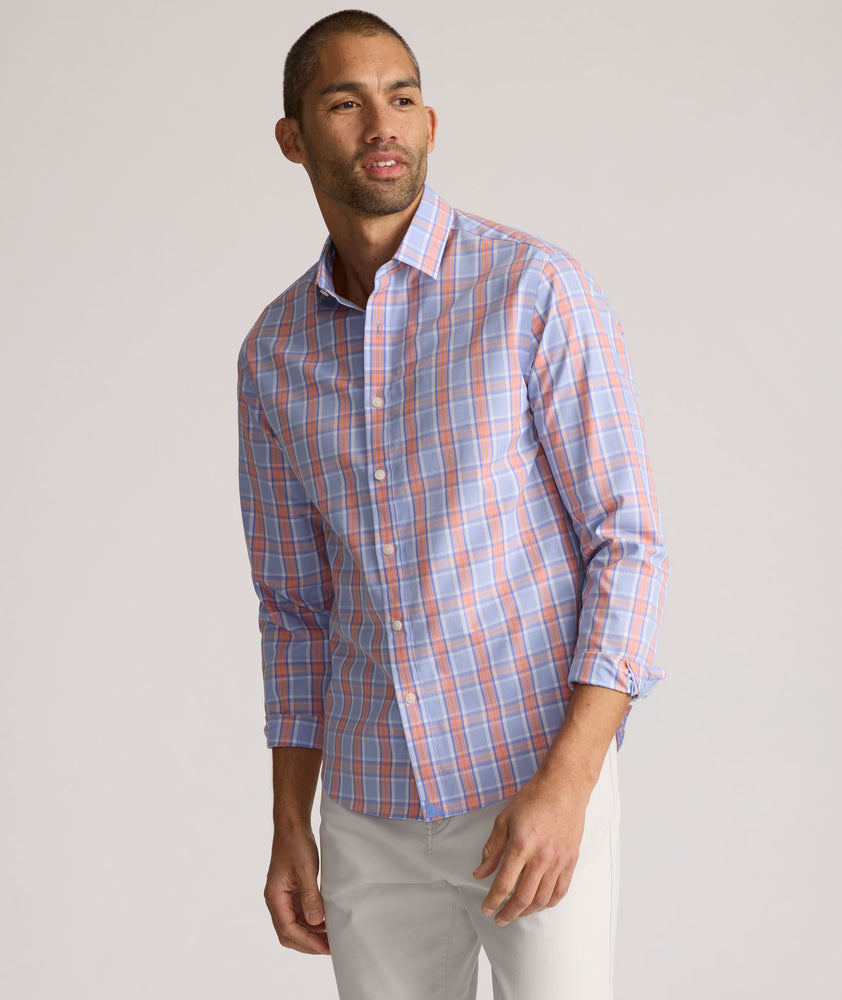 Model is wearing UNTUCKit ravenswood wrinkle free plaid plaid shirt in orange. 