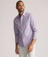 Model is wearing UNTUCKit ravenswood wrinkle free plaid plaid shirt in orange. 