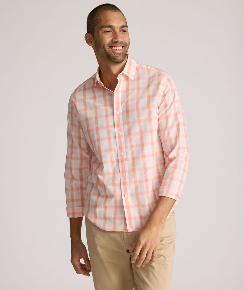 Model is wearing UNTUCKit ravenswood wrinkle free plaid plaid shirt in pink. 