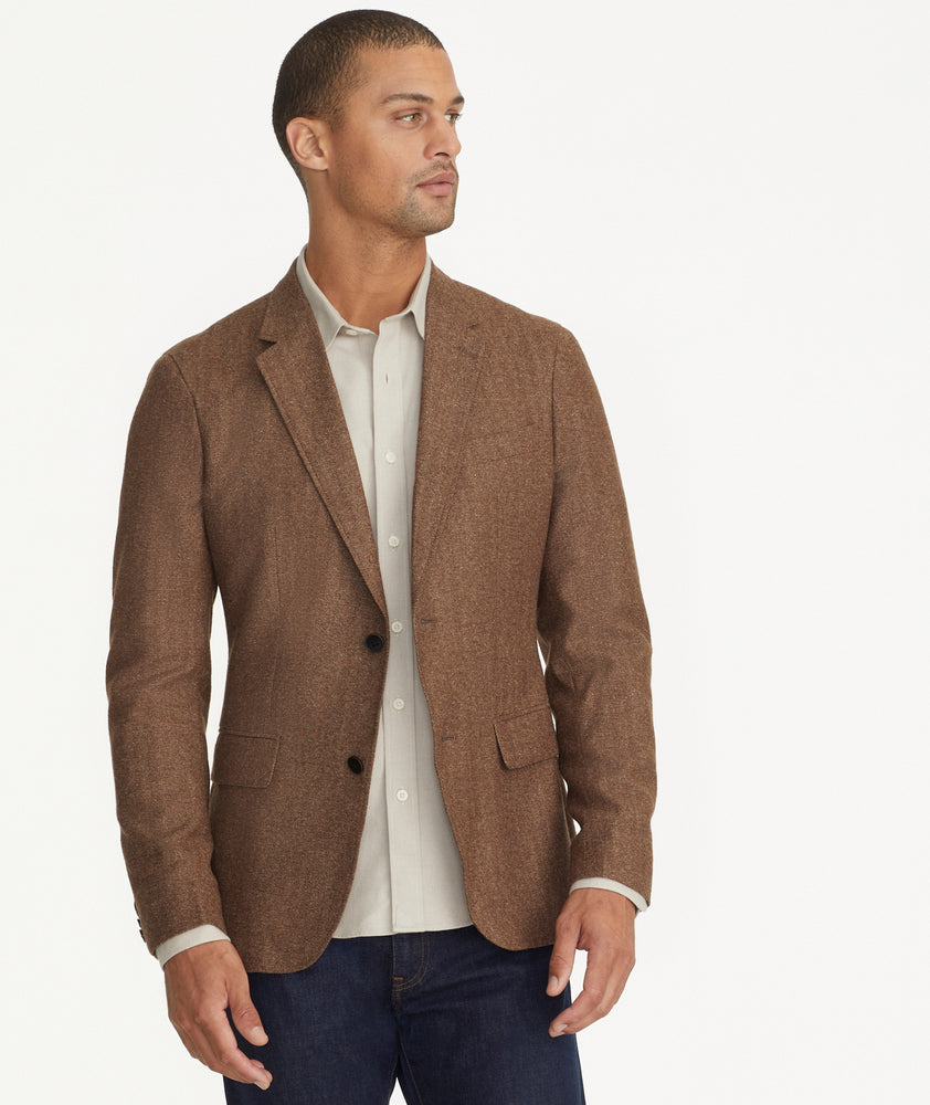 Model is wearing UNTUCKit Italian Wool Rawlins Sport Coat in Tan Herringbone.