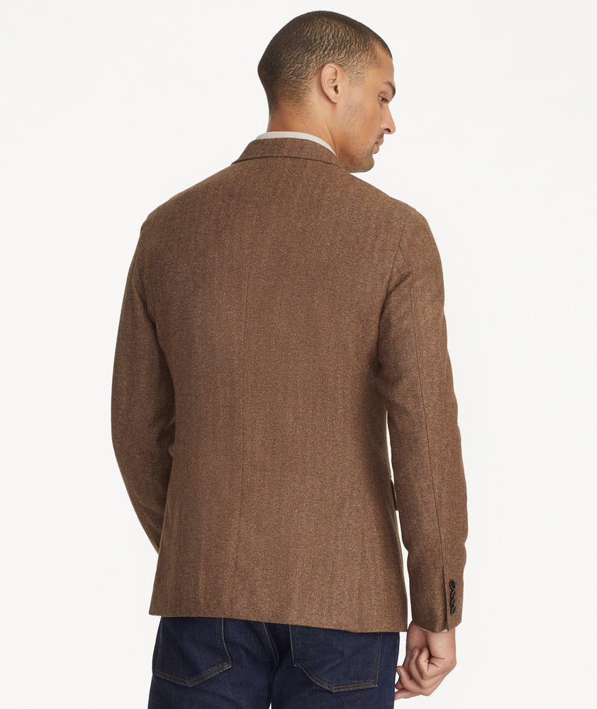 Model is wearing UNTUCKit Italian Wool Rawlins Sport Coat in Tan Herringbone.