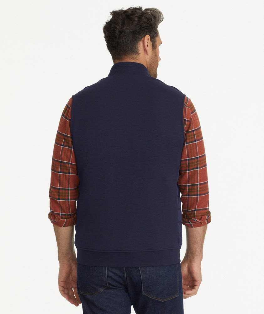 Model is wearing UNTUCKit Rebulo vest in navy.