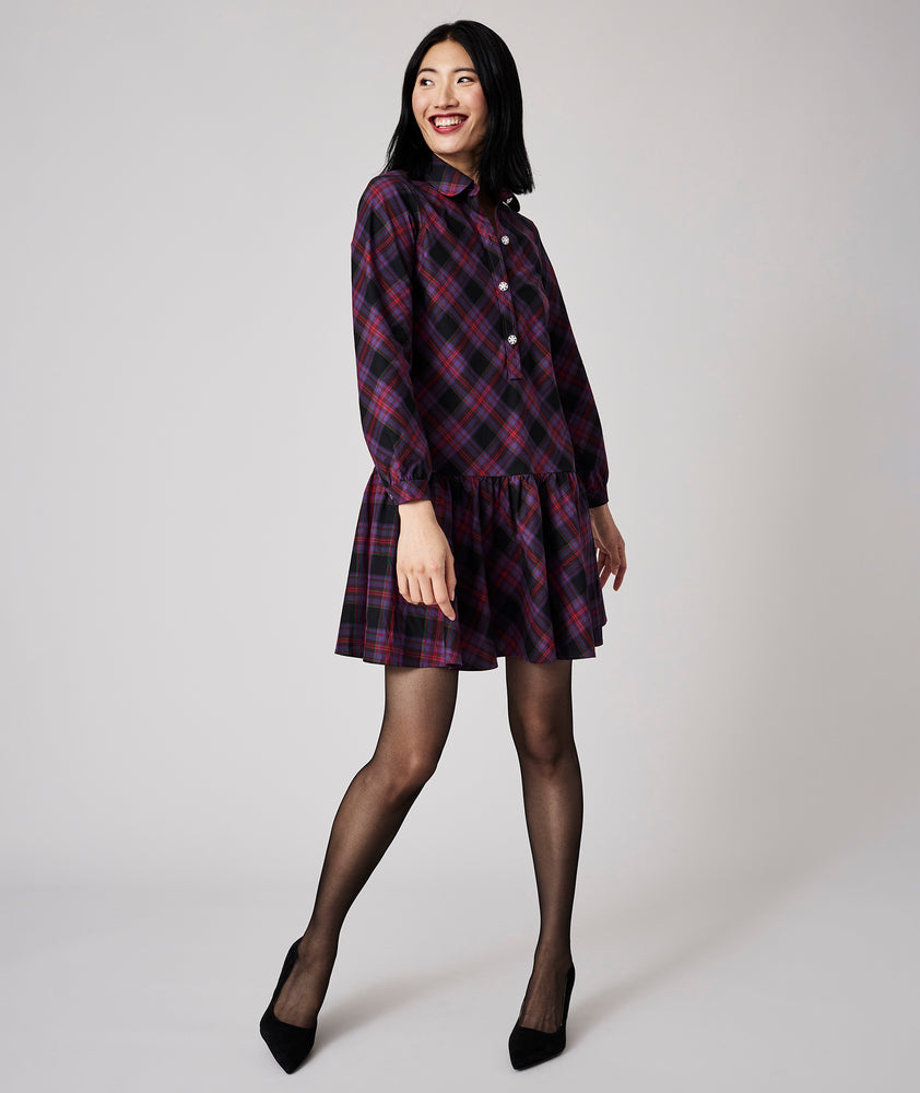 Model is wearing UNTUCKit Reese dress in purple plaid. 