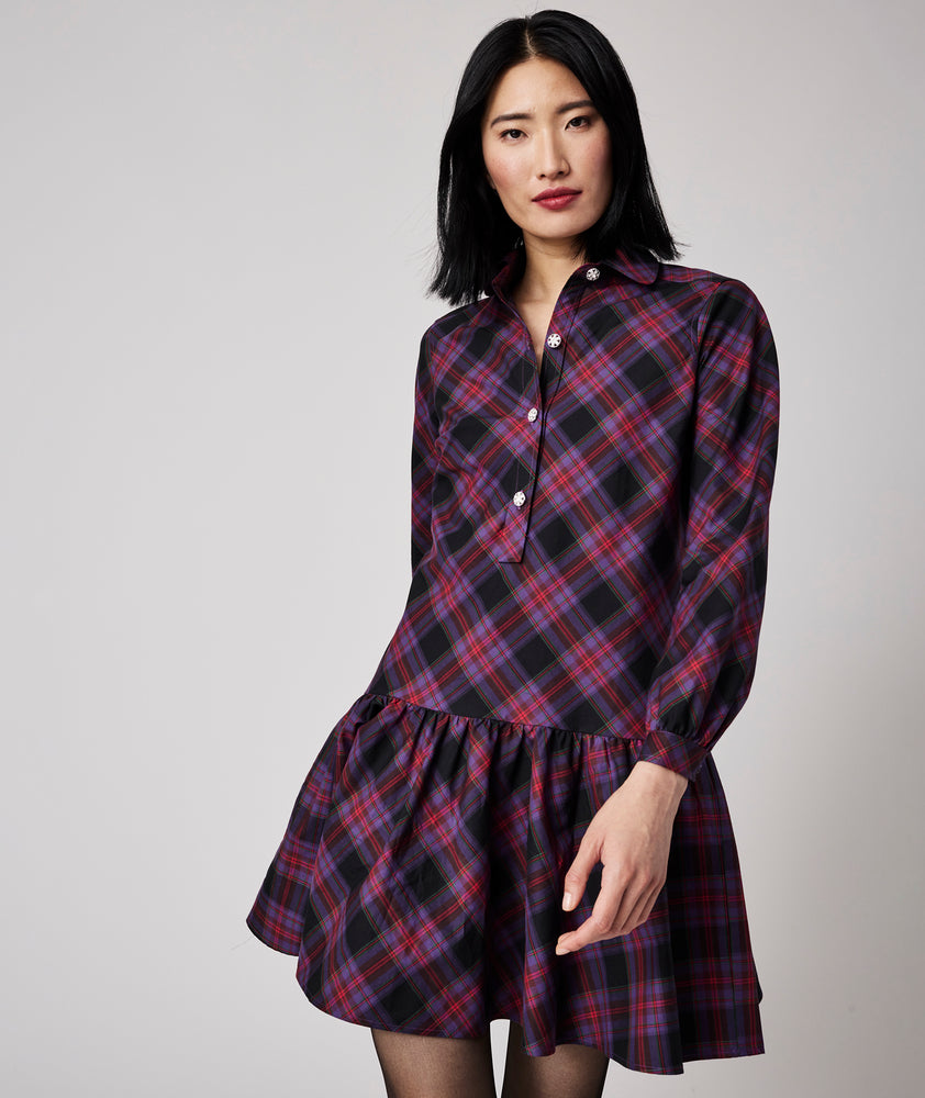 Model is wearing UNTUCKit Reese dress in purple plaid.