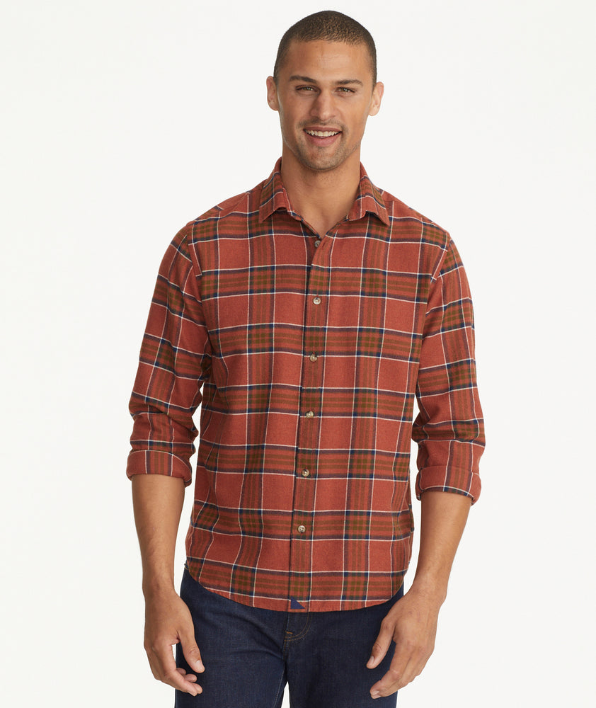 Model is wearing UNTUCKit Flannel Regner Shirt in Burnt Red Plaid.