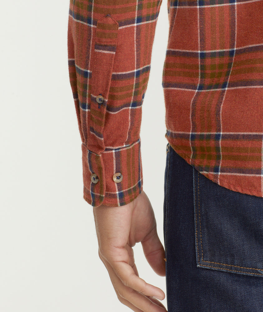 Model is wearing UNTUCKit Flannel Regner Shirt in Burnt Red Plaid.